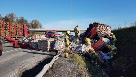 Wystrzeliła opona, ciężarówka wpadła do rowu. Paczki z celulozą na drodze